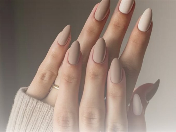 Matte nude almond manicure with a fine gold ring