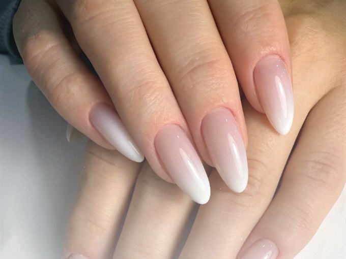 Nude ombré almond nail extensions with a seamless fade