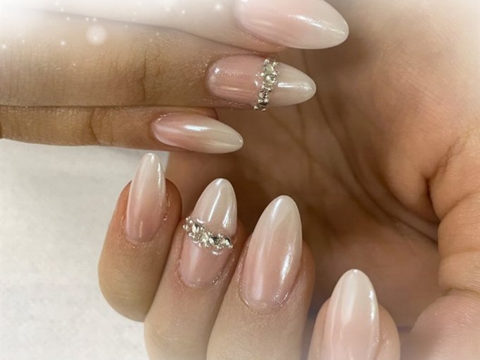 Pearl chrome nails finished with delicate crystal accents